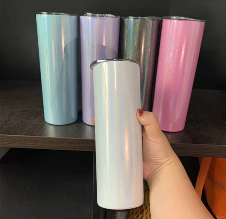 May include: Five stainless steel tumblers with iridescent finishes. The tumblers are in shades of light blue, lavender, iridescent, pink, and white.