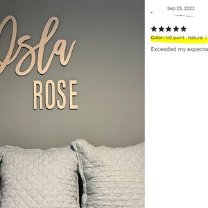 May include: A wooden sign with the name "Isla Rose" in cursive lettering. The sign is 30 inches long and is unpainted, showing the natural wood color. The sign is mounted on a gray wall.