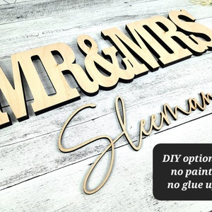 May include: Wooden "Mr & Mrs" sign with the last name "Sleeman" written in cursive underneath. DIY option = no paint, no glue up.