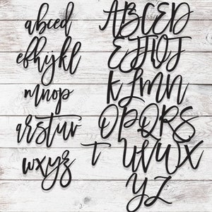 May include: A black and white image of the alphabet in a cursive font. The letters are arranged in rows, with the first row being A-D, the second row being E-J, the third row being K-N, the fourth row being O-S, the fifth row being T-X, and the sixth row being Y-Z.