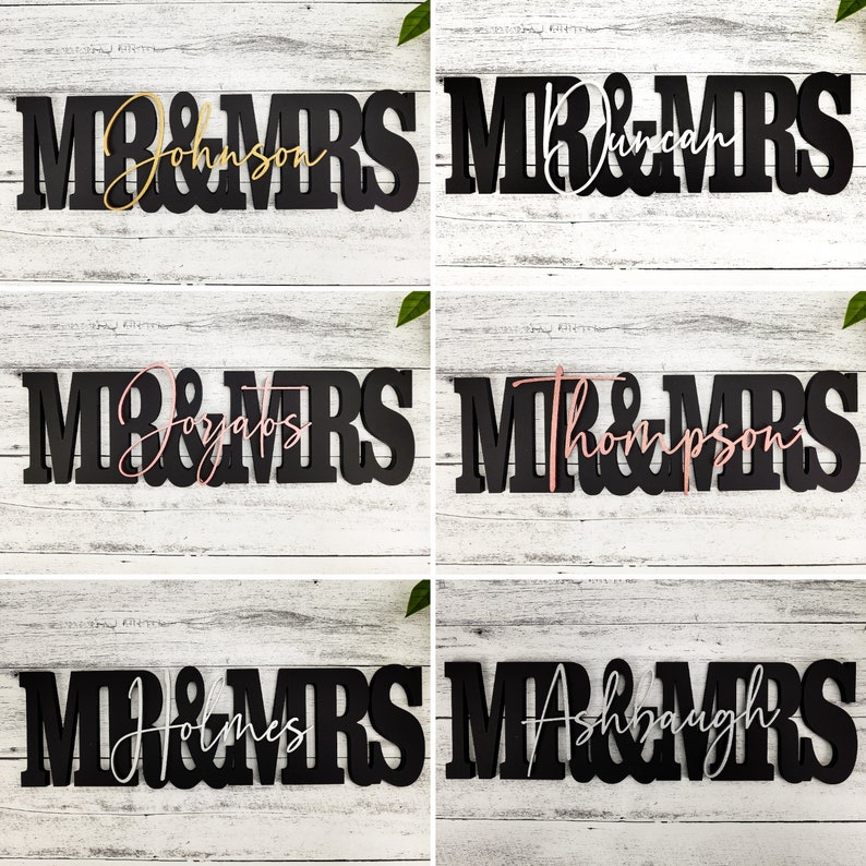 May include: Five black wooden signs with the words "Mr & Mrs" in white, gold, or pink lettering. The names are Johnson, Duncan,  Jozgaibis, Thompson, and Ashbaugh.