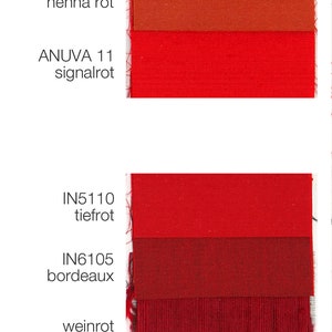 May include: Swatch card with 10 fabric samples in shades of red, pink, and burgundy. The fabric samples are labeled with color names and product codes, such as "coral", "henna rot", "tiefrot", "bordeaux", "weinrot", "purpur", and "beere".