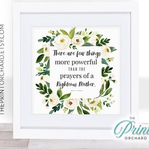 May include: White framed print with the text "There are few things more powerful than the prayers of a Righteous Mother." The text is surrounded by a watercolor floral wreath of white roses and green leaves.