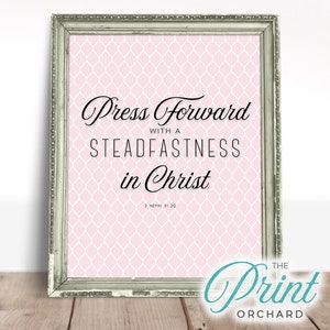 May include: A printable quote in a silver frame with a pink background and white geometric pattern. The quote reads "Press forward with a steadfastness in Christ. 2 Nephi 31:20".