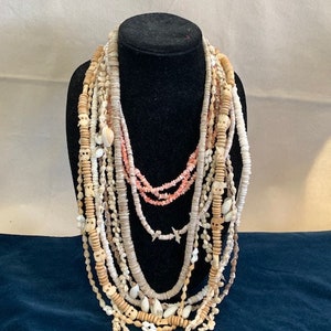 11 sea shell necklaces, sold as a collection
