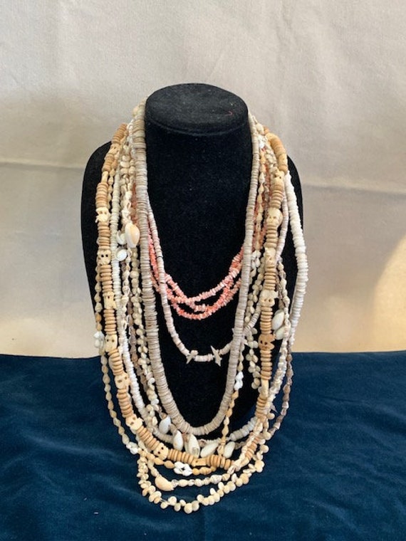 11 sea shell necklaces, sold as a collection