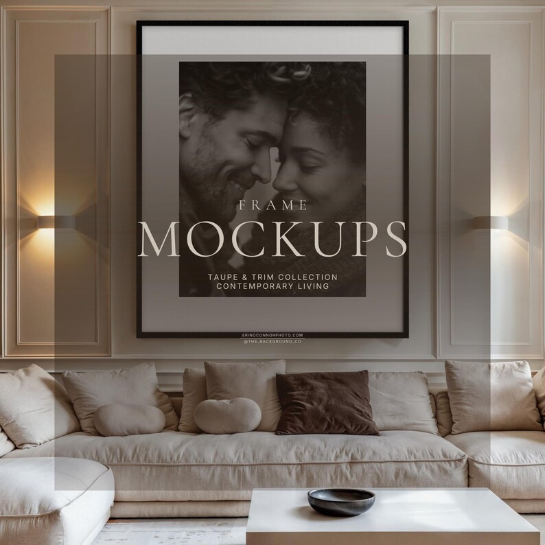 Contemporary living room wall art mockup with oversized square black frame, cream sectional sofa, wall sconces, warm lighting, and black and white portrait