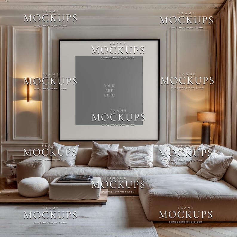 Blank vertical frame mockup in taupe contemporary living room with cream sectional sofa, black gallery frame, warm sconces, pillows, and coffee table