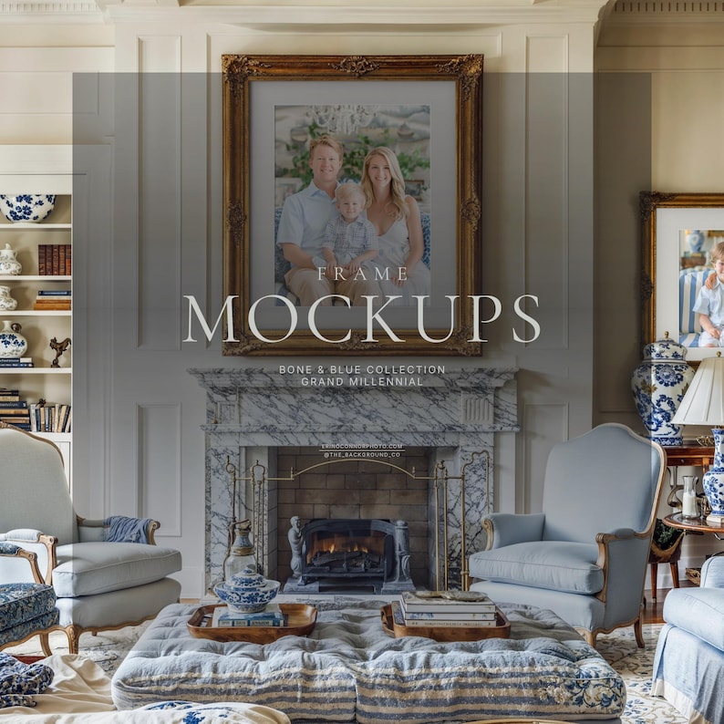 Grand millennial living room wall art mockup with ornate gold frame above marble fireplace, bone white walls, blue chairs, and family portrait display