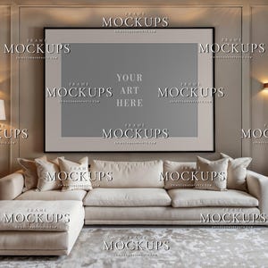 Blank contemporary living room wall art mockup with large horizontal black frame, taupe wall trim, cream sectional sofa, lamps, curtains, and neutral decor