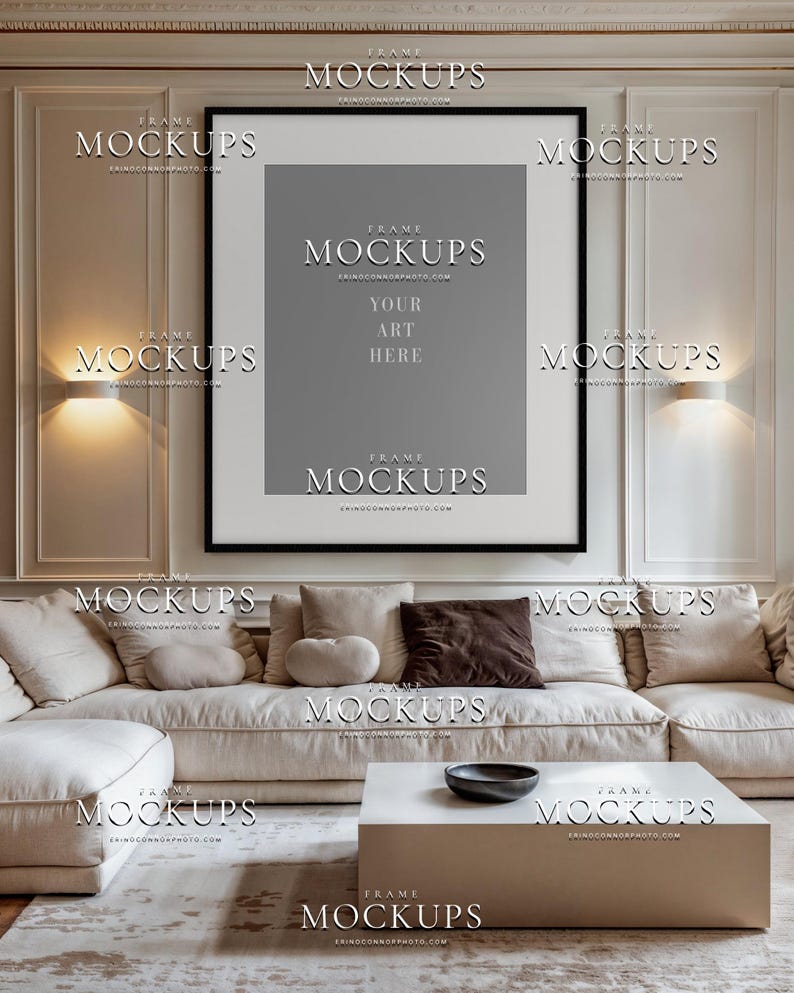 Blank square frame mockup in contemporary taupe living room with cream sofa, wall trim, warm sconces, table lamp, neutral curtains, and soft decor