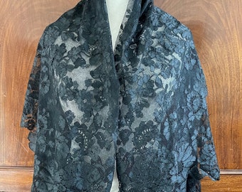 A large antique silky black lace shawl - damaged.