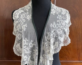 A long antique lace collar, ivory with black binding.