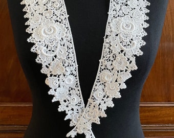 A vintage shiffli lace collar with raised design in white