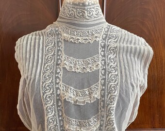 An antique Edwardian lace chemisette bodice in ivory.