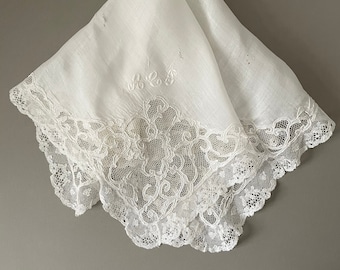 A large antique lace handkerchief in ivory - damaged.