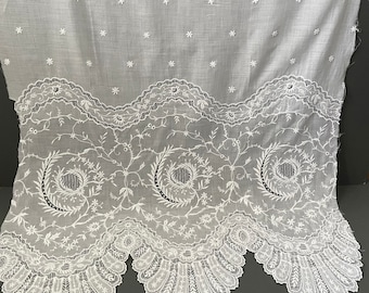 A vintage embroidered lace offcut panel on fine white cotton lawn.