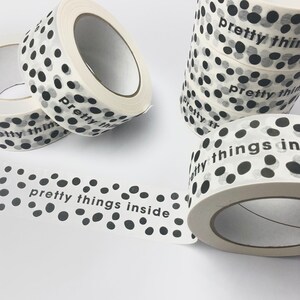 May include: White washi tape with black polka dots and the text "pretty things inside".