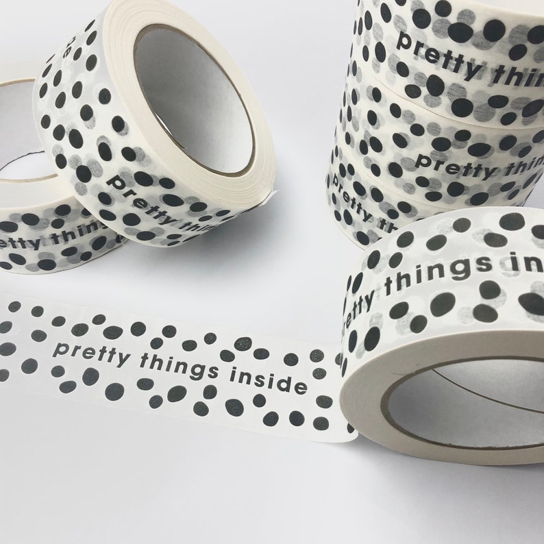 May include: White washi tape with black polka dots and the text "pretty things inside".