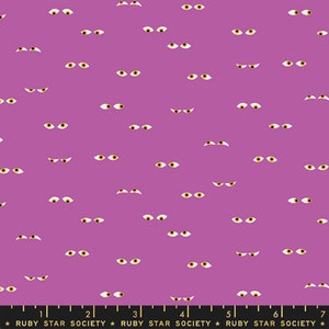 May include: A purple fabric with a repeating pattern of cartoon eyes. Each eye has a yellow iris and white sclera. The eyes are in various orientations, creating a spooky, Halloween-themed design. The text "RUBY STAR SOCIETY" is at the bottom.