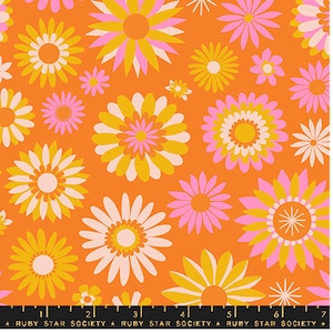 May include: Vibrant orange fabric with a repeating pattern of large, stylized flowers in shades of yellow, pink, and white. The flowers have multiple petals and circular centers. The text "RUBY STAR SOCIETY" is printed along the bottom edge.