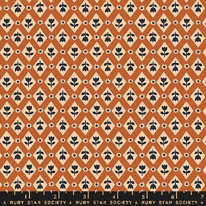 May include: A repeating pattern fabric featuring a diamond grid design. Each diamond contains a stylized dark blue tulip. The background is a warm orange-brown color. Small starbursts and floral elements fill the spaces between the diamonds. The text "RUBY STAR SOCIETY" is at the bottom.