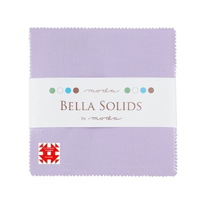 May include: A stack of lavender fabric squares, with a white band wrapped around the middle. The band features the text "BELLA SOLIDS by moda" and a series of colored dots. A small logo with a red and white design is in the lower left corner.