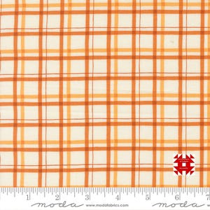 May include: Cream-coloured fabric featuring a plaid pattern in shades of orange and yellow. The fabric has a grid-like design with varying line thicknesses. A ruler is at the bottom, and a logo is in the bottom right corner.