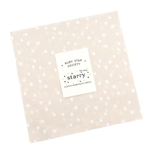 May include: A square, beige fabric with a repeating pattern of small, white stars. A white label with the text "RUBY STAR SOCIETY" and "starry" is centered on the fabric. The label also includes the text "new colors!" and "ALEXIA MARCELLE ABEGG".