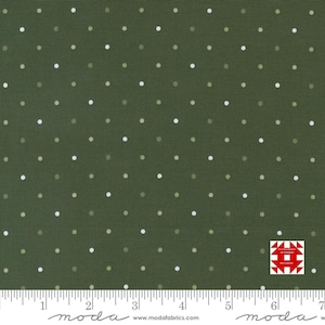 May include: Dark green fabric with a repeating pattern of small white and light green polka dots. The fabric has a ruler along the bottom edge and a logo in the bottom right corner. The fabric is likely used for quilting or sewing projects.