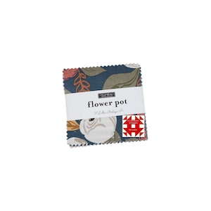 May include: A stack of fabric squares with a floral pattern in shades of blue, white, and rust. The fabric is wrapped with a white band that reads "flower pot". A red and white quilt block design is visible.