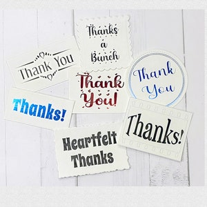 May include: Assortment of thank you cards with different fonts and colors. The cards feature phrases like "Thank You", "Thanks a Bunch", "Heartfelt Thanks", and "Thank You!"