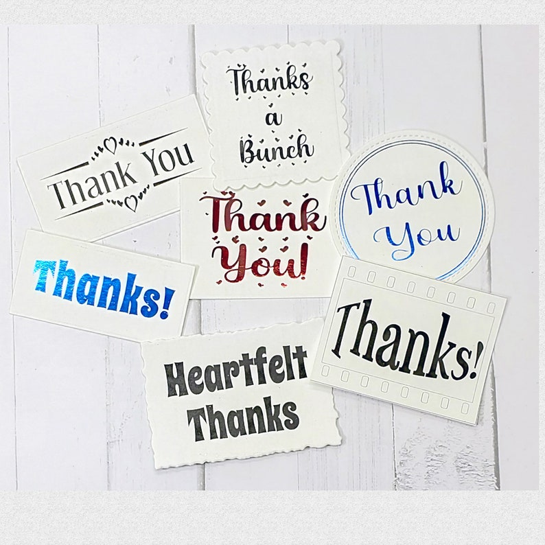 May include: Assortment of thank you cards with different fonts and colors. The cards feature phrases like "Thank You", "Thanks a Bunch", "Heartfelt Thanks", and "Thank You!"