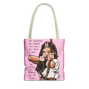May include: Pink tote bag featuring an illustration of a person aiming a bow and arrow. The bag has a light pink border and handles. Text on the bag reads: "He teaches my hands to war, so that a bow of steel is broken by my arms. Psalm 18:34."