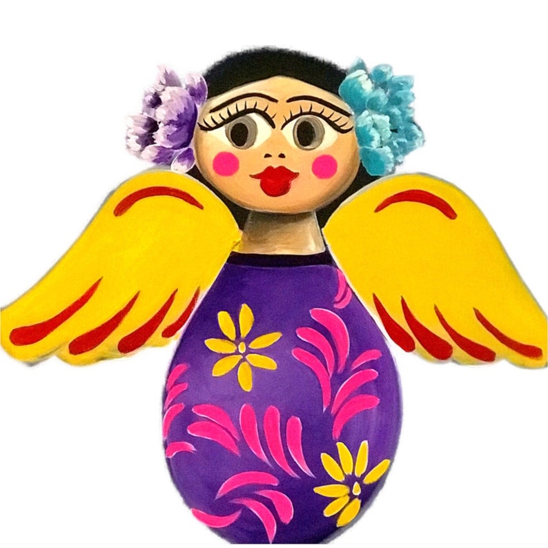 May include: A colorful wooden angel figurine with yellow wings, a purple dress with pink and yellow floral designs, and a painted face with brown hair, blue eyes, and red lips.