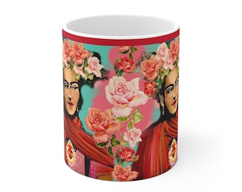 May include: White ceramic mug with a red rim and a colorful design featuring a woman with flowers in her hair. The design is a repeating pattern of the woman's face and pink roses.