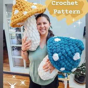 May include: A woman holds two large crocheted mushroom pillows. One mushroom is yellow with white dots and the other is blue with white dots. The text "Crochet Pattern" is written in white on a yellow background.