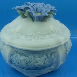 May include: A set of three ceramic vases in varying heights. The vases are white with a textured, ribbed design. The tallest vase is approximately 10 inches tall, the medium vase is 8 inches, and the smallest is 6 inches.