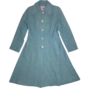 May include: A vintage teal coat with a flared skirt and a collared neckline. The coat features six gold-colored buttons down the front and two pockets. The interior lining is a light purple color.