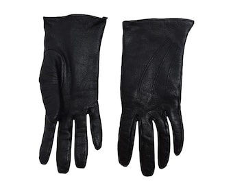 May include: A pair of black leather gloves. The gloves have a smooth, textured surface and are designed for a classic look.