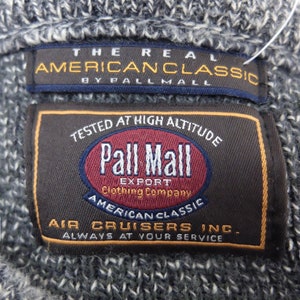 May include: A brown and black label with the text "Pall Mall Export Clothing Company" and "American Classic Air Cruisers Inc. Always at your service". The label also features a red circle with the text "Pall Mall" in white.