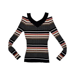 May include: A long-sleeve ribbed sweater featuring a cold-shoulder design and a V-neckline. The garment is decorated with horizontal stripes in black, white, red, and tan. The ribbed texture runs vertically throughout the entire piece.