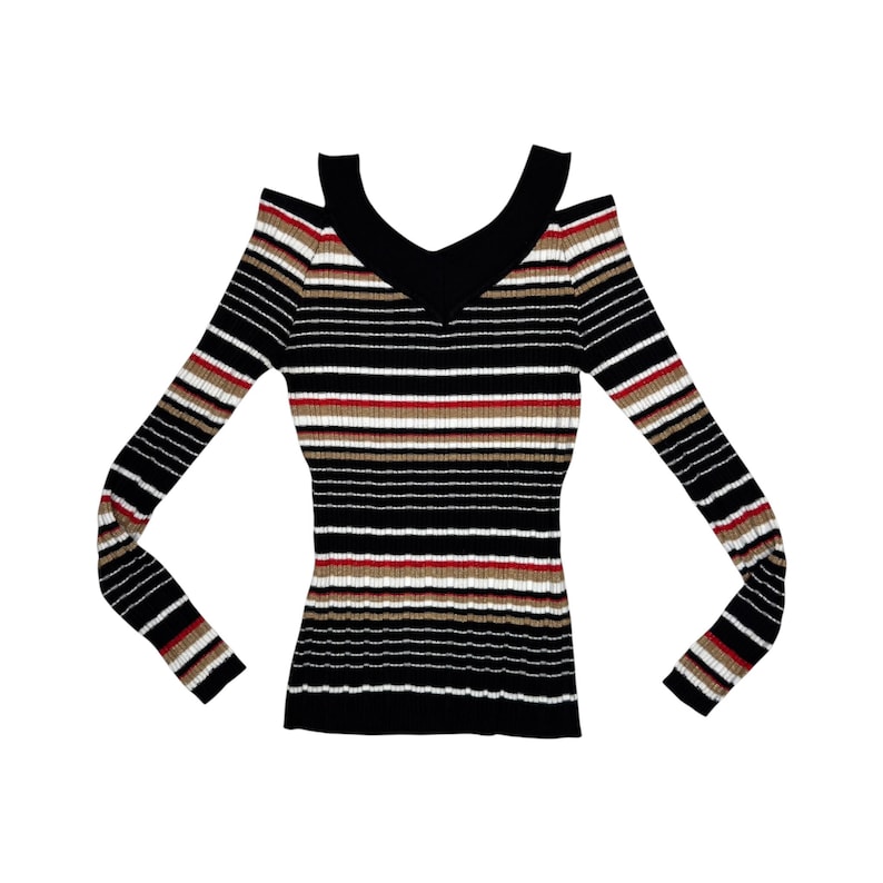 May include: A long-sleeve ribbed sweater featuring a cold-shoulder design and a V-neckline. The garment is decorated with horizontal stripes in black, white, red, and tan. The ribbed texture runs vertically throughout the entire piece.