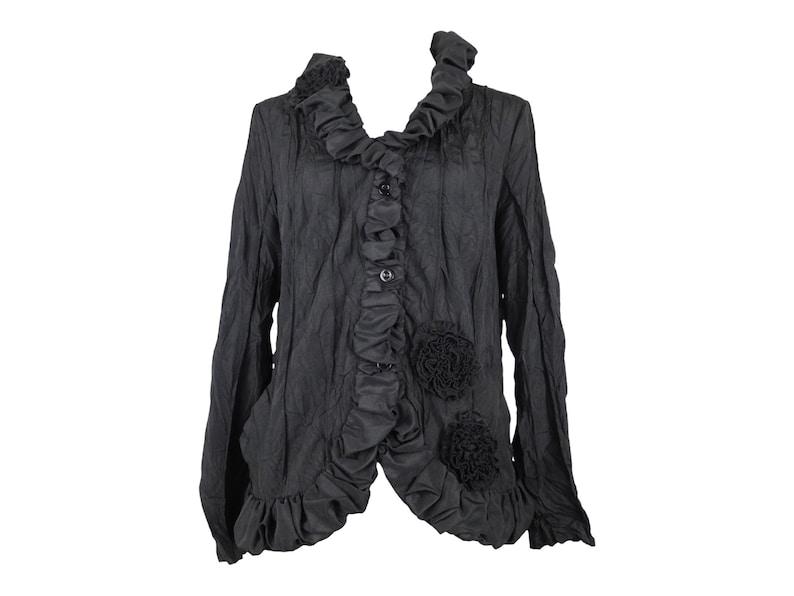 May include: A black ruffled blouse with a high collar and floral embellishments.