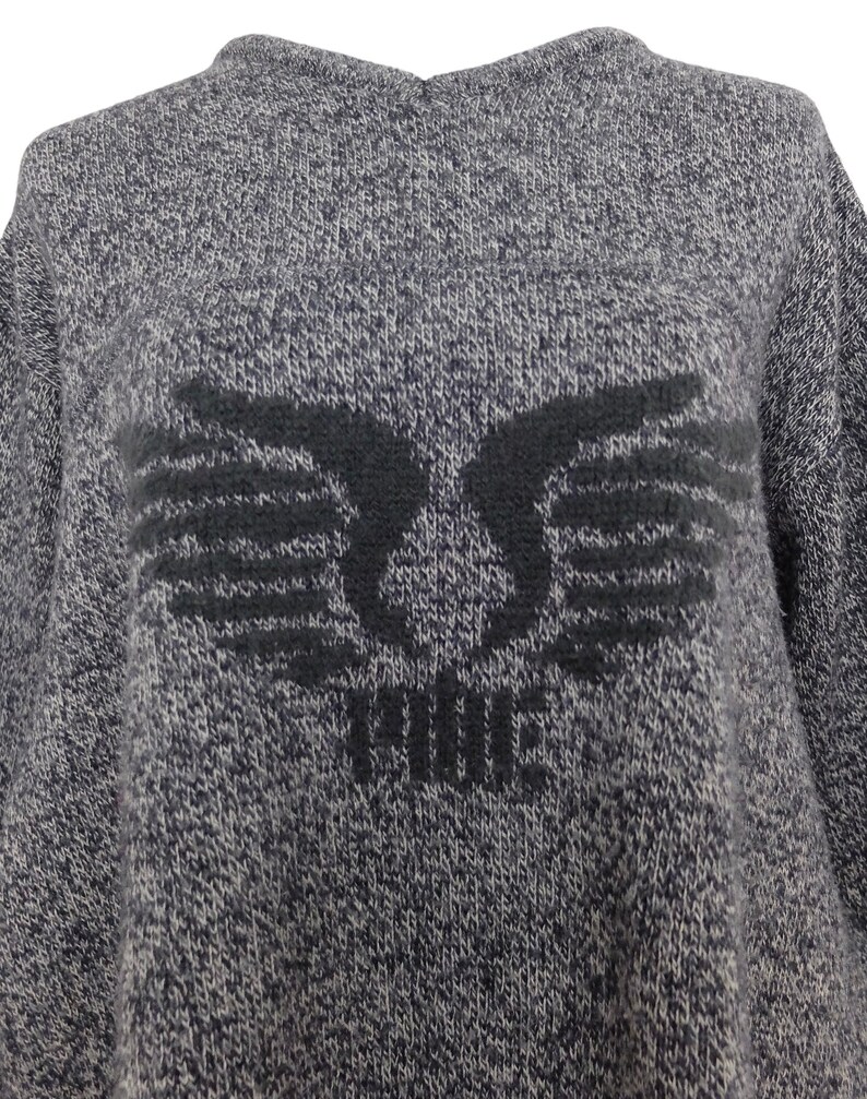 May include: Gray sweater with a black embroidered design of wings and the word "FORCE" in the center.