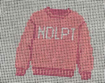 May include: A needlepoint canvas featuring a pink long-sleeve sweater design with a ribbed collar, cuffs, and hem. The word NOLPT is stitched in white capital letters across the center of the chest. The design is set against a white grid background.
