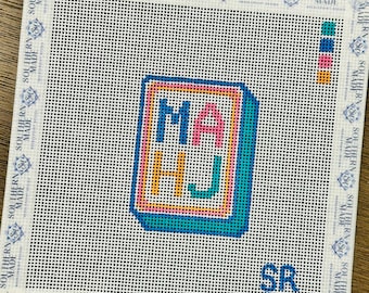 May include: Needlepoint canvas with the letters "MA HJ" in a colorful, blocky design. The letters are outlined in a bright pink, with a teal border. The canvas has a white background with the text "SOUTHERN MADE" around the edges.