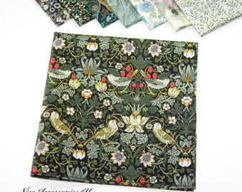 May include: A dark green fabric with a repeating pattern of stylized flowers, leaves, and birds. The fabric has a subtle sheen and a soft texture.