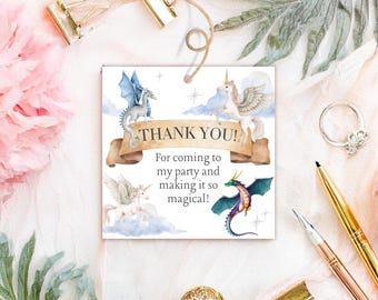 May include: A square card with a watercolor design featuring a banner that reads "THANK YOU!" and illustrations of a dragon and unicorns. The text below says "For coming to my party and making it so magical!"
