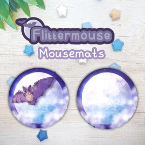 May include: Two round mousepads with a purple and blue watercolor design. One mousepad features a purple bat flying in front of a full moon. The mousepads are labeled "Flittermouse Mousemats".